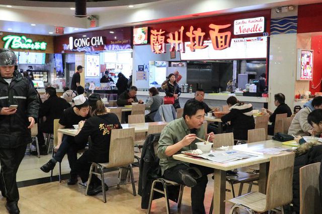 Diners eating at the food court at New World Mall in Flushing.